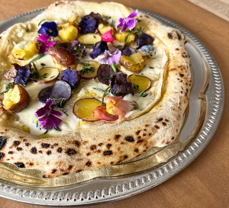 Pizza bianca med farvede kartofler, urter og friske blomster